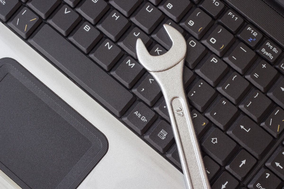 Spanner On The Laptop Keyboard, The Concept Of Repairing Machinery